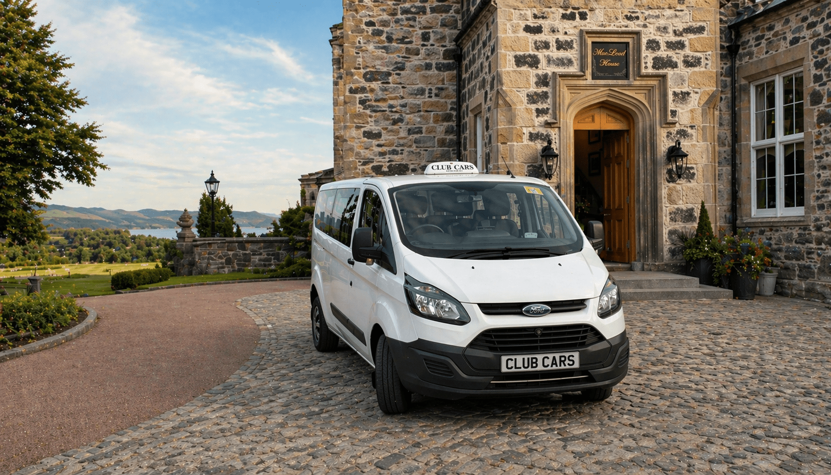 Club Cars minivan at Scottish castle with loch view
